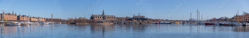 Panorama view over the bay Ladugårdsviken, piers with boats and museums a sunny winter day in Stockholm