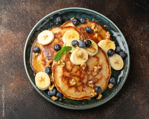 American pancakes with banana, blueberry, walnut and honey. Healthy morning breakfast