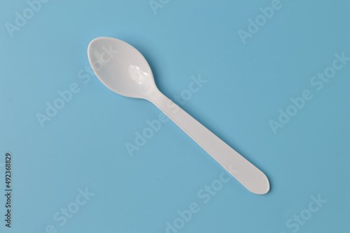 Plastic spoon isolated on a blue background