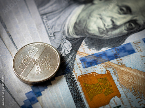 Belarus rouble coin on a hundred dollar bill. Belarus and USA money. Currency exchange. Economic crisis. War in Ukraine effect. Financial analytics. Investment and banking. Business 