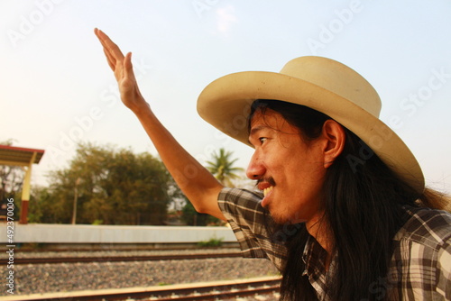 portrait of a cowboy waving hand to say hi