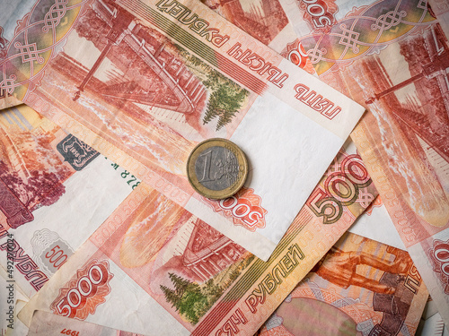 Euro and rouble. Foreign currency exchange. Russia and EU. Economic crisis. Russian money. Investment, business and finance. Emerging markets. Money background. Money in cash. Euro coin on roubles