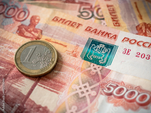 Euro and rouble. Foreign currency exchange. Russia and EU. Economic crisis. Russian money. Investment, business and finance. Emerging markets. Money background. Money in cash. Euro coin on roubles
