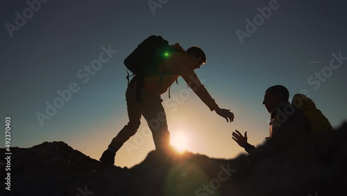 Family team success.Silhouette of group people.Climb to the top of mountain.Helping hand family victory.Teamwork concept.Business handshake.Helping hand of business people.Teamwork is path to success