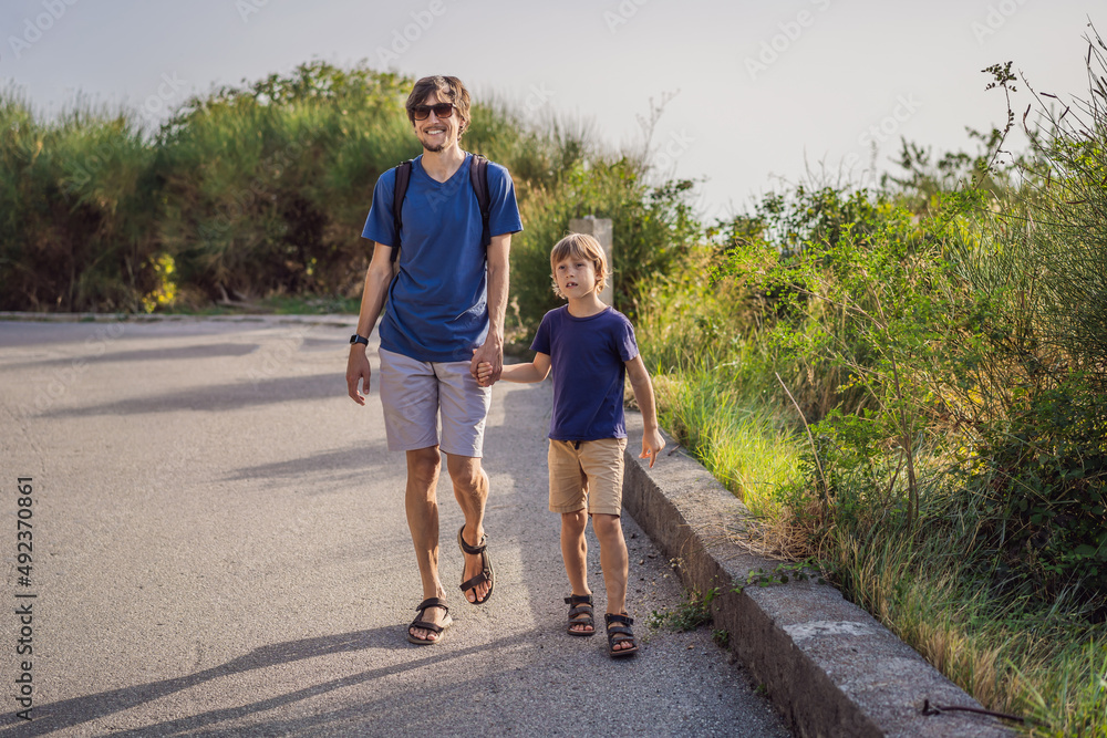 father and his son walking in a national park