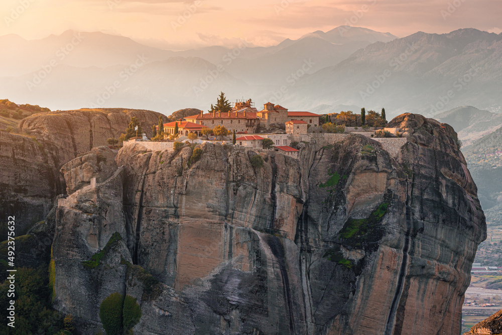 Atmospheric distant view of the Monastery of the Holy Trinity in Meteora. Tourist and pilgrimage inspirations. Natural and religious wonders of Greece.