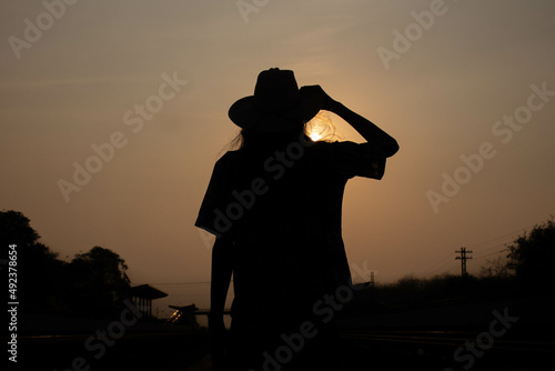 silhouette of a cowboy with countryside in twilight time.