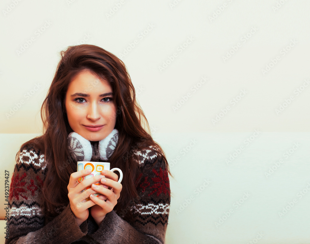 young pretty woman sitting in comfortable chair with coffee and blanket, winter season lifestyle people concept young pretty woman sitting in comfortable chair with coffee and blanket, winter season lifestyle people concept