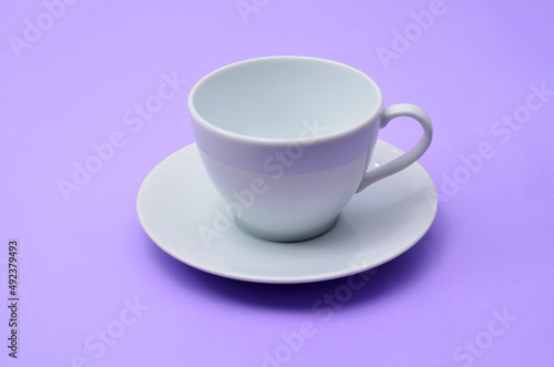 White empty coffee cup on a purple background.