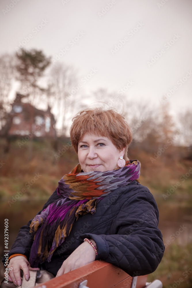 Elderly woman in black jacket and colored scarf Elderly woman in black jacket and colored scarf