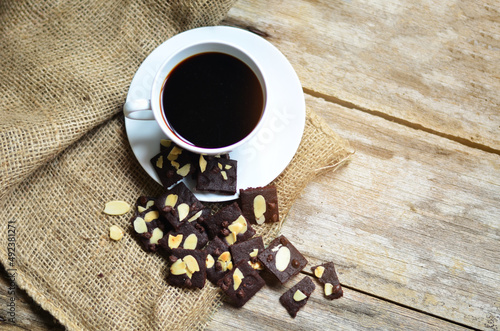 Cup of coffee and tasty cookies on wooden background. Tea time and breakfast concept.