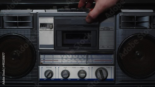 Male hand turning an antiquarian record player on. The concept of retro things