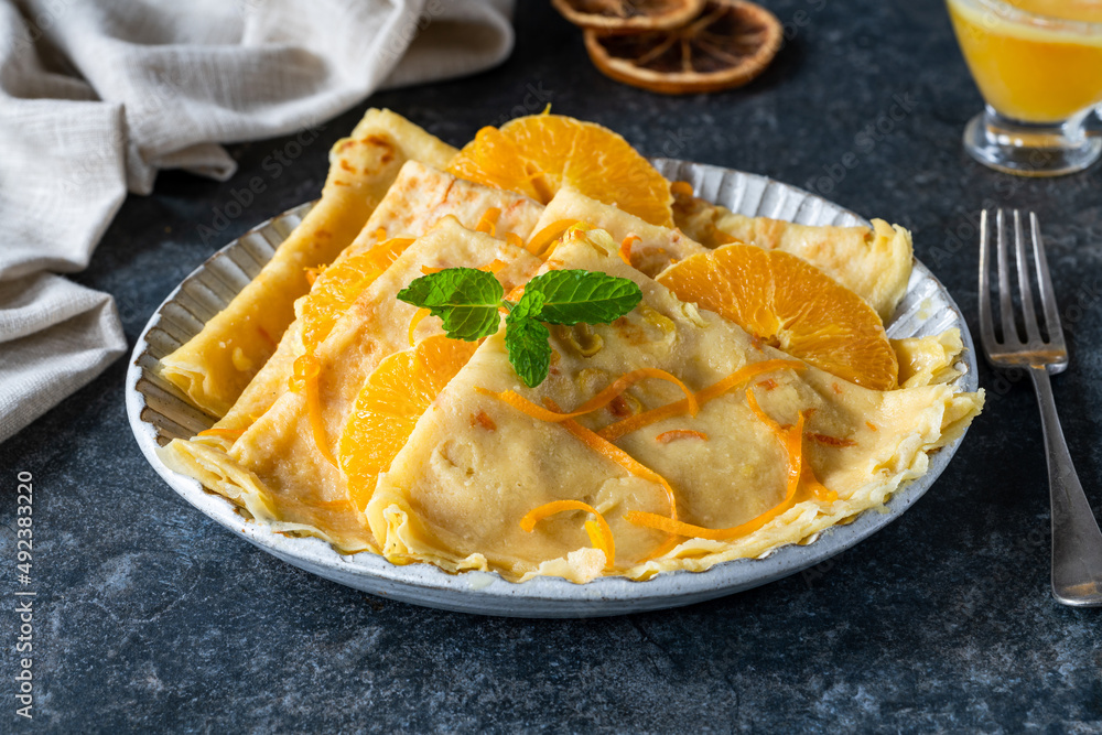 Crepes Suzette - French pancakes with orange liqueur sauce Crepes Suzette - French pancakes with orange liqueur sauce