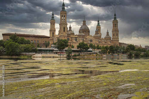 The Basilica del Pilar over the Ebro river under cloudy sky. Zaragoza, Aragon, Spain photo