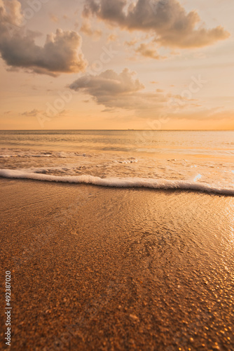 Fototapeta Naklejka Na Ścianę i Meble -  Beautiful sand beach with waves, wonderful clouds in the sky during a dramatic sunset - Koh Lanta Thailand