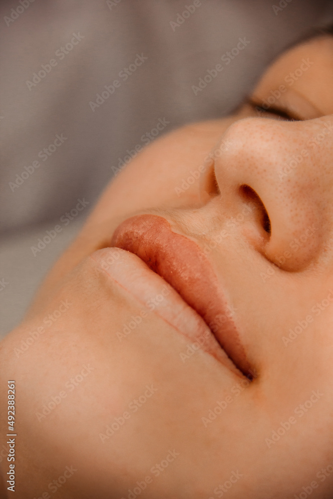 half result of permanent lips tattoo. closeup one permanent lip tattoo. camera from top. beauty concept, free space half result of permanent lips tattoo. closeup one permanent lip tattoo. camera from top. beauty concept, free space