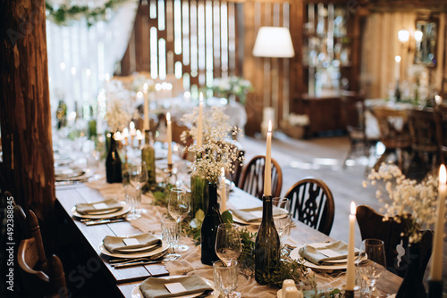 Decoration of wooden vintage tables in the restaurant for a festive dinner in a rustic style