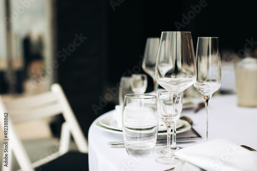 Empty wine glasses on the table for a festive dinner. © Yevhenii Kukulka