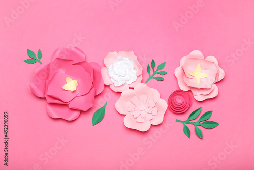 Beautiful handmade paper flowers on pink background photo