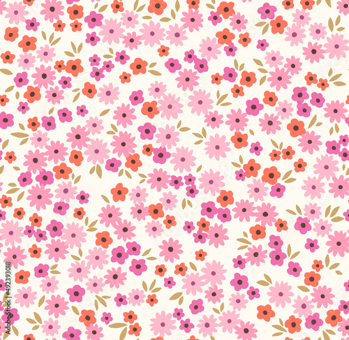 Beautiful floral pattern in small abstract flowers. Small pink and orange flowers. White background. Ditsy print. Floral seamless background. The elegant the template for fashion prints. Stock.