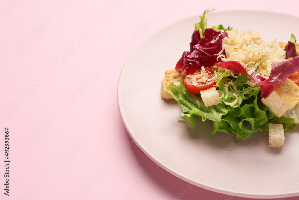 Plate with tasty vegan Caesar salad on pink background, closeup Plate with tasty vegan Caesar salad on pink background, closeup