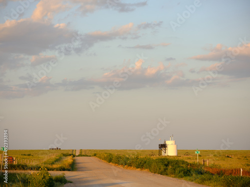 Gravel highway 460 in the flatlands of Kansas at sunset