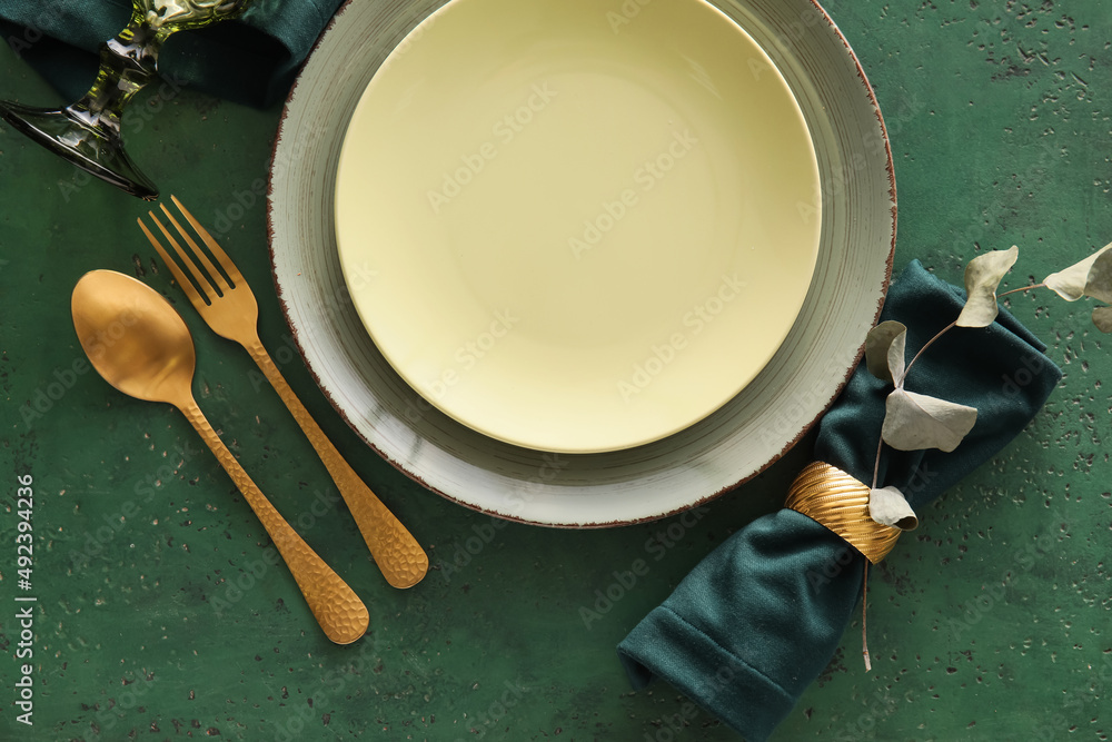 Elegant table setting on green background Elegant table setting on green background