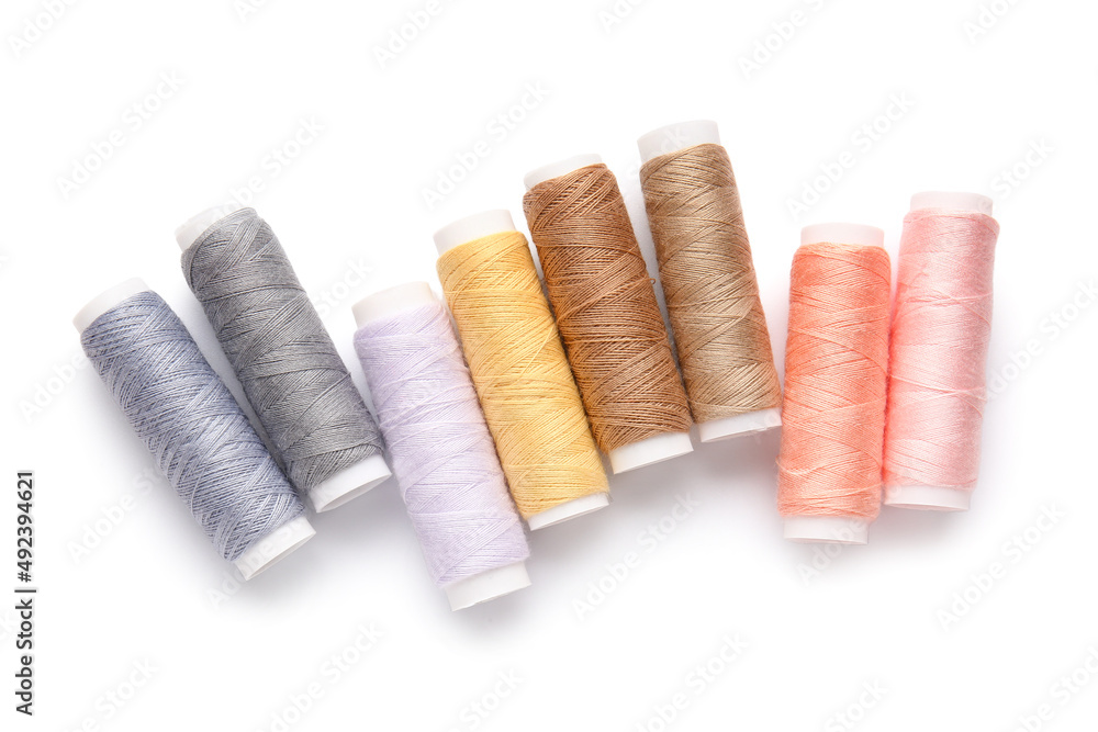 Different thread spools on white background Different thread spools on white background