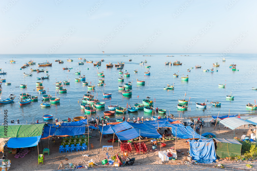 Colorful round Vietnamese fishing boats in the sea. locals sell seafood