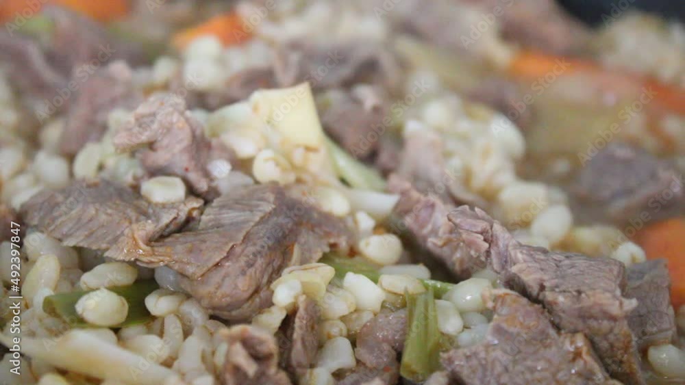 Cooking beef meat and vegetables , carrot, leek and wheat, close up view Cooking beef meat and vegetables , carrot, leek and wheat, close up view