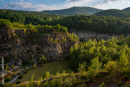 View of Lake Krasnoe in an abandoned gypsum quarry in the vicinity of Khadjokh on a sunny summer day, Kamennomostsky village, Republic of Adygea, Russia