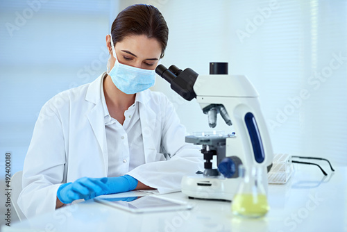 Observe carefully to help maintain accuracy. Shot of a female scientist working alone in the lab.