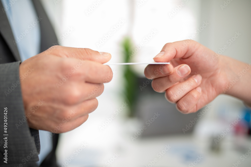 Manager giving his business card to a customer