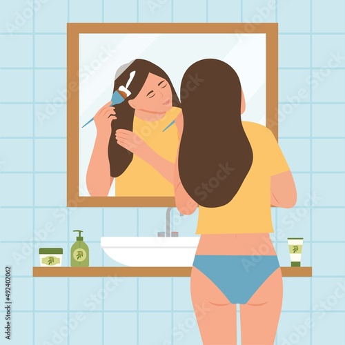 Cute young woman standing in front of mirror and cleansing or moisturizing her skin. Everyday personal care, skincare daily routine, hygienic procedure. Flat cartoon colorful vector illustration.