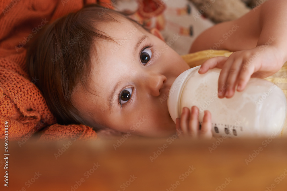 Drinking A Bottle Before Bed A Little Girl Looking Up At The Camera drinking-a-bottle-before-bed-a-little-girl-looking-up-at-the-camera