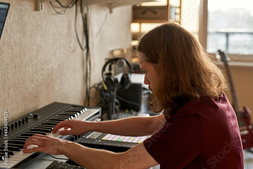 Cropped of man playing piano and recording music