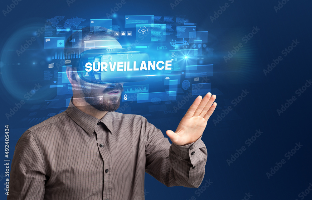 Businessman looking through Virtual Reality glasses Businessman looking through Virtual Reality glasses