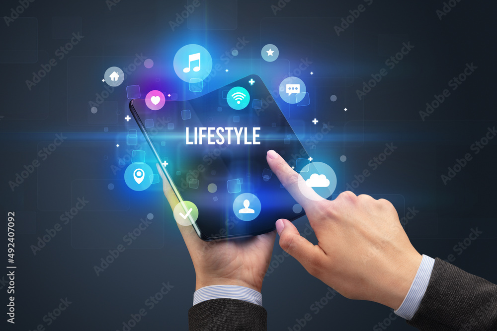 Businessman holding a foldable smartphone Businessman holding a foldable smartphone