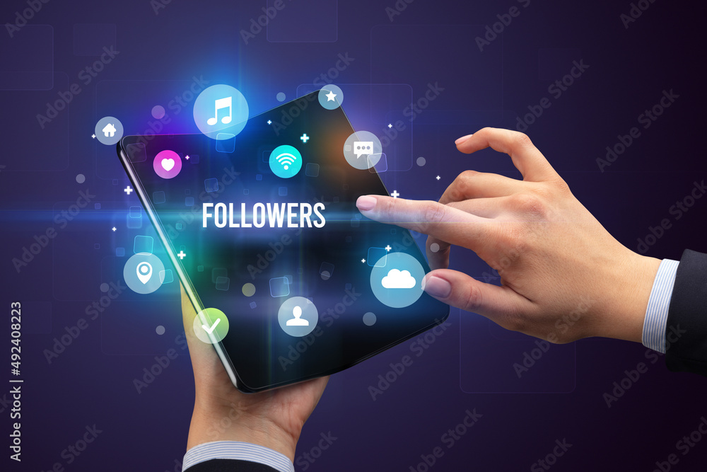Businessman holding a foldable smartphone Businessman holding a foldable smartphone