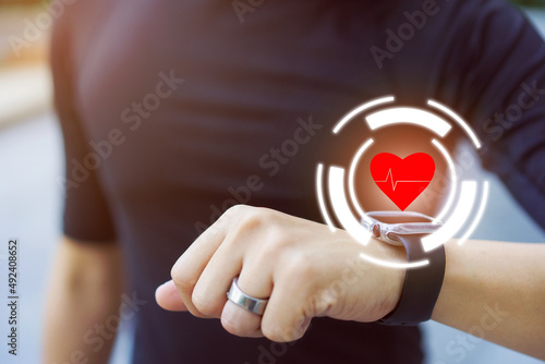 Unrecognizable active Asian young man using smartwatch for exercise - workout and health tracking.
