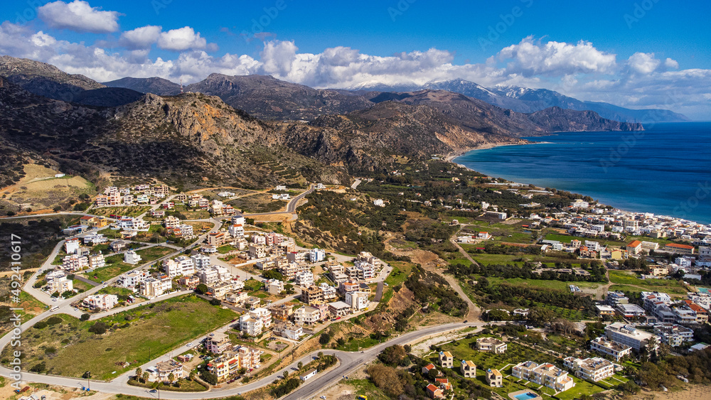 Scenic aerial shot of Paleochora and the coastline with the white mountains in crete, Greece