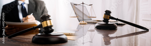 Male lawyer working with contract papers and wooden gavel on tabel in courtroom. justice and law ,attorney, court judge, concept.