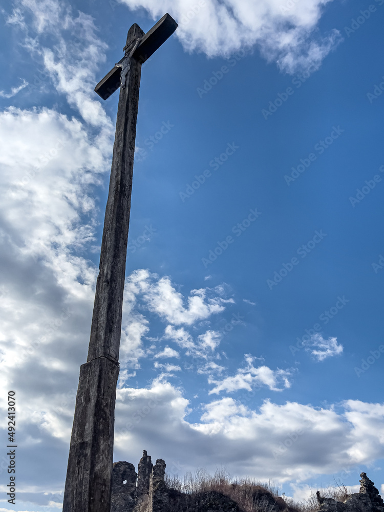 Wooden cross with the crucifixion of Jesus Christ against the sky.