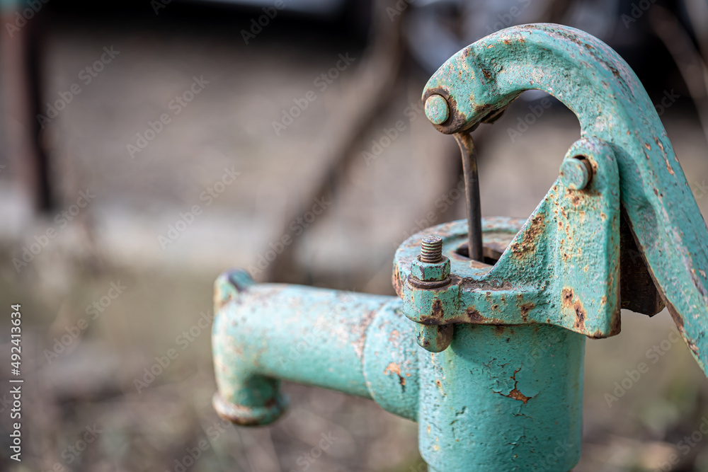 Part old blue iron water tap stands outside. Part old blue iron water tap stands outside.