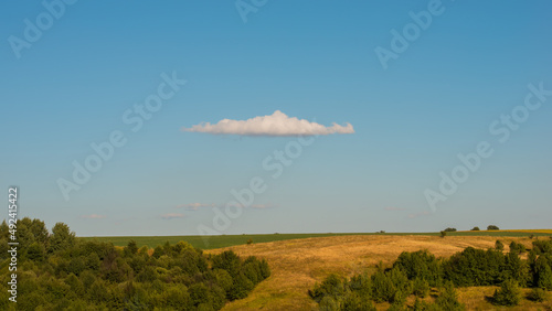 Cloud over the field and hills, panoramic landscape.