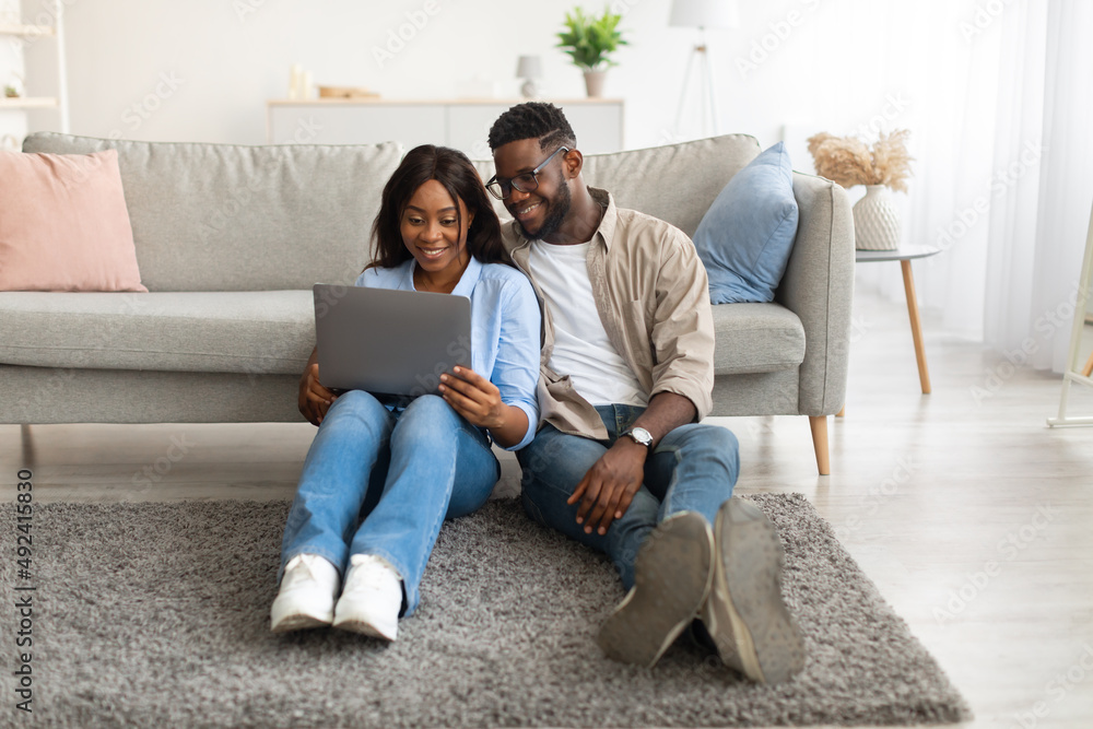 Portrait of African American couple using personal computer Portrait of African American couple using personal computer