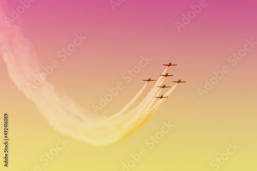 Fighter jets in the shape of in the gradient sky beautiful sunset. photo