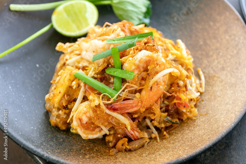 Pad Thai (Stir-fried rice noodles with shrimp) flavor with sugar, lime, ground dried chilies and peanuts; Thailand's popular dishes. photo