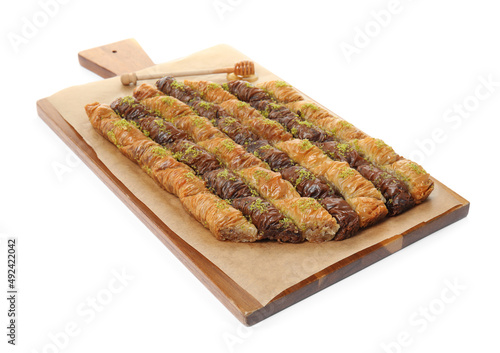Delicious sweet baklava and honey dipper on white background