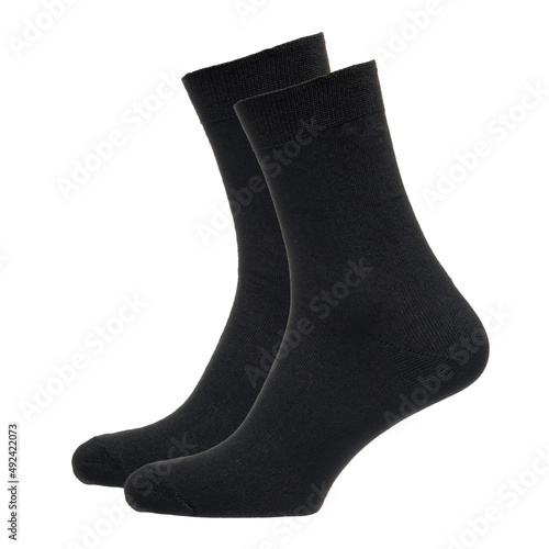 A pair of fabric socks stands on a white isolated background. Volumetric socks on a transparent mannequin. Black men's socks.